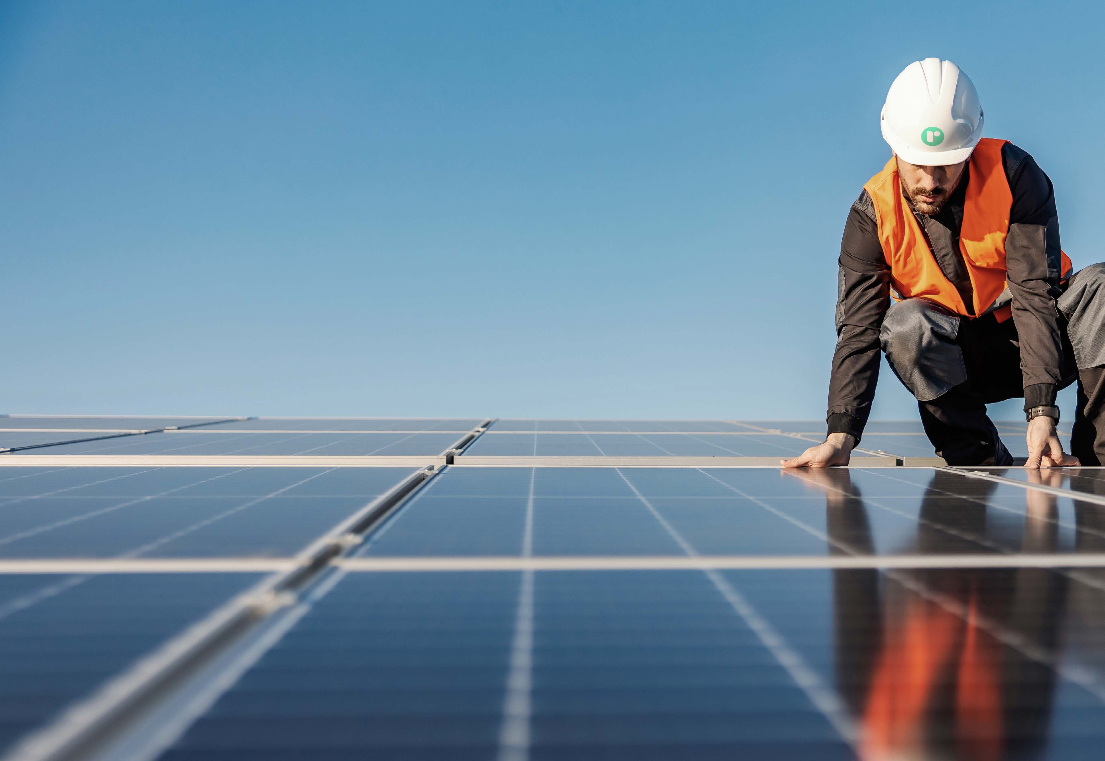 Railton Energy specialist inspecting solar panels on a school roof